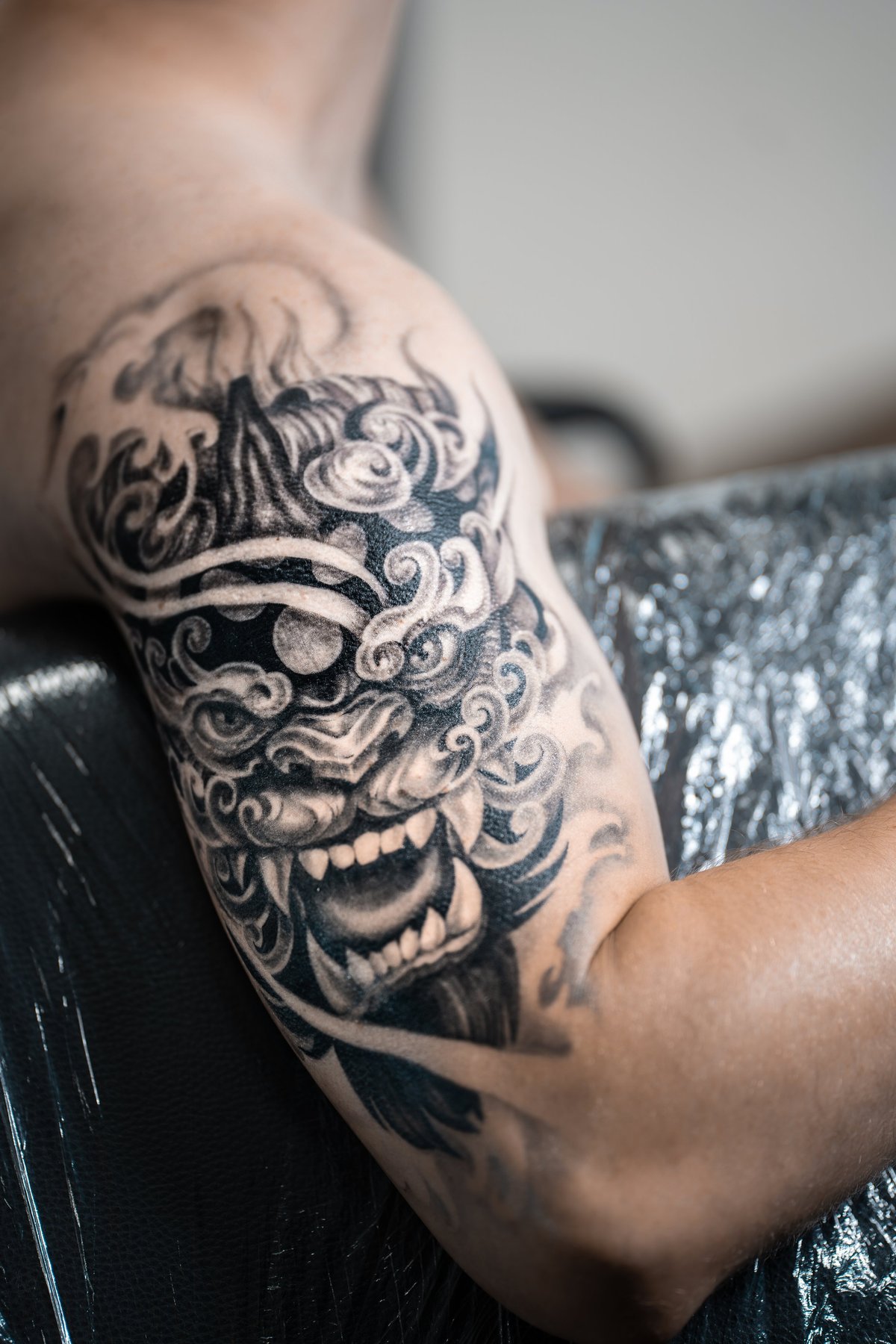 stylish black tattoo of Japanese demon mask on man hand, body art. High quality photo