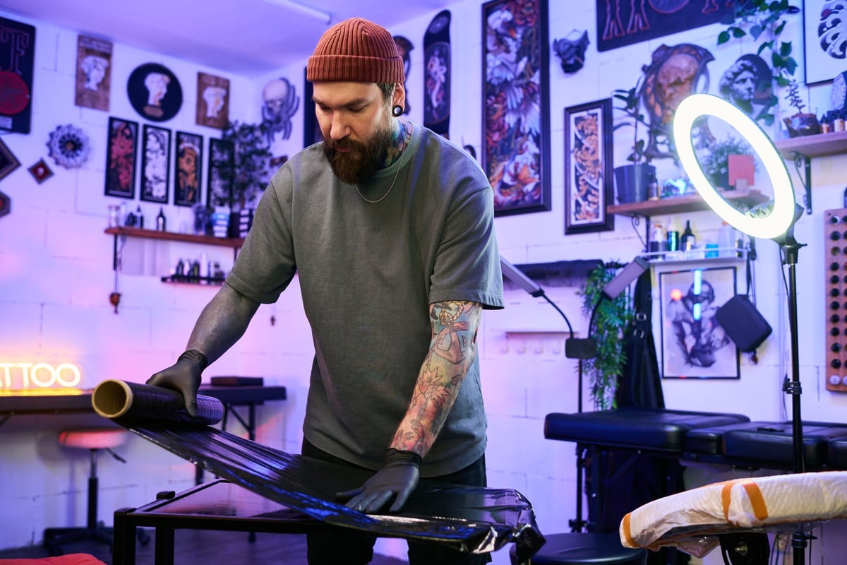 Professional tattoo artist preparing workstation