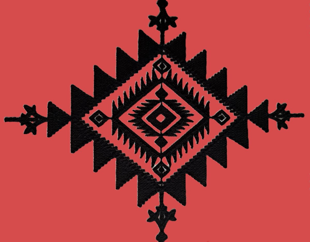 a black Aztec star pattern on a red background
